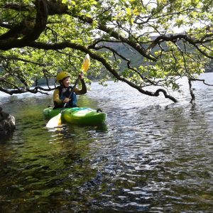 Kayaking on Coniston Water under trees